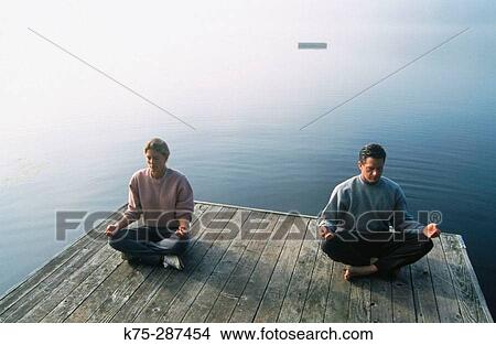 two people meditating on dock View Large Photo Image Picture - two people meditating on dock. Fotosearch