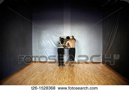 Stock Photo - Two people taking money from the cashier. China country. Fotosearch
