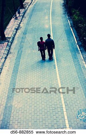 two people walking in the old river bed of Turia River, Valencia, Spain View Large Photo Image Stock Photography - two people walking in the old river bed of Turia River, Valencia, Spain. Fotosearch