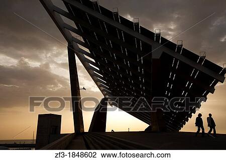 Two people walking under a giant solar panel in Barcelona View Large Photo Image Stock Image - Two people walking under a giant solar panel in Barcelona. Fotosearch