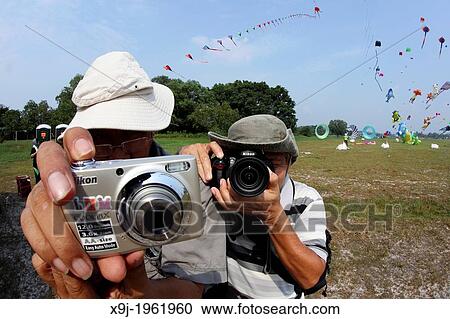 two photographer with digital camera during International Kite Festival in Bintulu, sarawak, Malaysia, Borneo View Large Photo Image Stock Image - two photographer with digital camera during International Kite Festival in Bintulu, sarawak, Malaysia, Borneo. Fotosearch