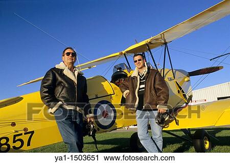 Two pilots with flying jackets near old British trainer biplane De Havilland DH 82a Tiger Moth used by the Royal Air Force View Large Photo Image Stock Image - Two pilots with flying jackets near old British trainer biplane De Havilland DH 82a Tiger Moth used by the Royal Air Force. Fotosearch
