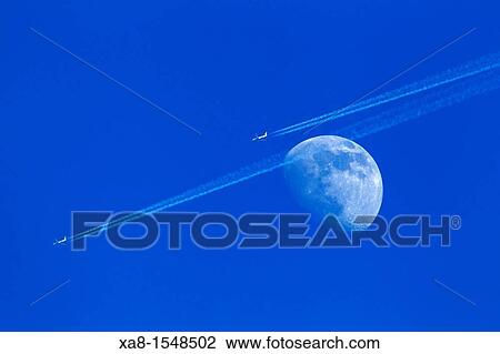 Stock Image - two plane fly close the moon. Fotosearch