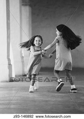 Two playful little girls View Large Photo Image Stock Image - Two playful little girls. Fotosearch