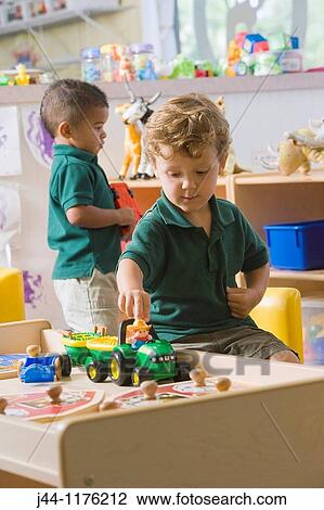 Two preschooler boys playing in the classroom with toys View Large Photo Image Stock Image - Two preschooler boys playing in the classroom with toys. Fotosearch