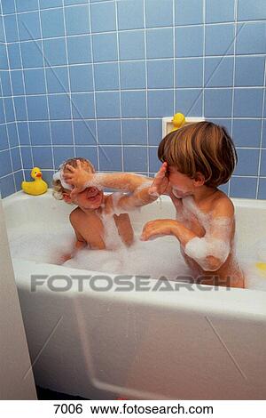 Stock Photograph - Two rambunctious brothers in bubble bath. Fotosearch