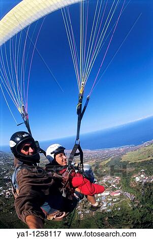 Two seater paraglider flying over Saint Leu countryside, Reunion Island (France), Indian Ocean View Large Photo Image Stock Photo - Two seater paraglider flying over Saint Leu countryside, Reunion Island (France), Indian Ocean. Fotosearch