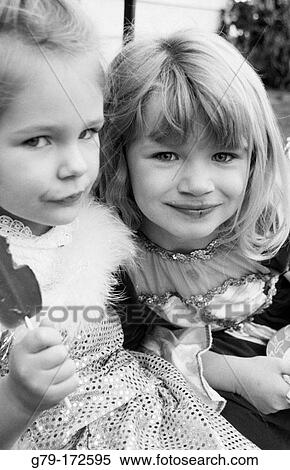 Two sister in dress up clothes eating ice cream View Large Photo Image Stock Photography - Two sister in dress up clothes eating ice cream. Fotosearch