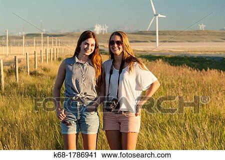 Two sisters, 16 and 20, stand in a field in southern Alberta, Canada View Large Photo Image Stock Image - Two sisters, 16 and 20, stand in a field in southern Alberta, Canada. Fotosearch