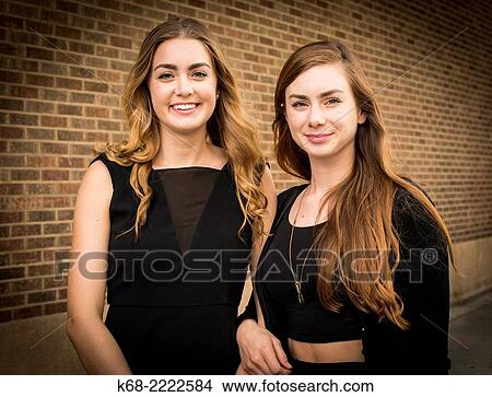 two sisters, 18 and 22, in an outdoor portrait View Large Photo Image Picture - two sisters, 18 and 22, in an outdoor portrait. Fotosearch