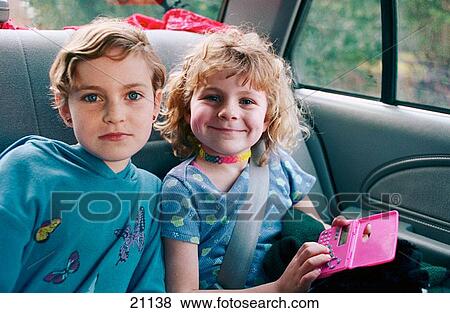 Two sisters as passengers in a car on a family outing View Large Photo Image Stock Photo - Two sisters as passengers in a car on a family outing. Fotosearch