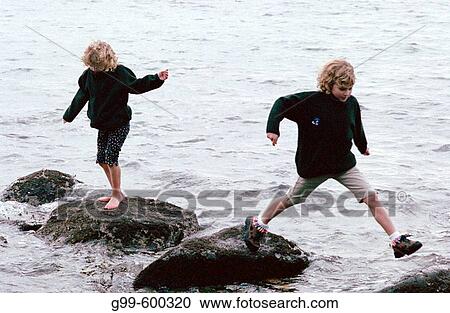 Two sisters run along a beach near Vancouver, British Columbia, Canada View Large Photo Image Stock Image - Two sisters run along a beach near Vancouver, British Columbia, Canada. Fotosearch