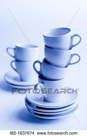 two stacks of cups and saucers for coffee blue on blue background View Large Photo Image Picture - two stacks of cups and saucers for coffee blue on blue background. Fotosearch
