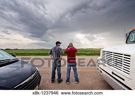 Two storm chasers watch and wait for a storm to develop near Pickstown, South Dakota, USA, June 3, 2010 View Large Photo Image Stock Photograph - Two storm chasers watch and wait for a storm to develop near Pickstown, South Dakota, USA, June 3, 2010. Fotosearch