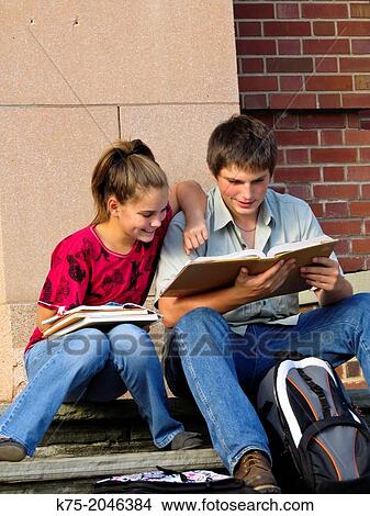 Two students studying together on school steps View Large Photo Image Picture - Two students studying together on school steps. Fotosearch