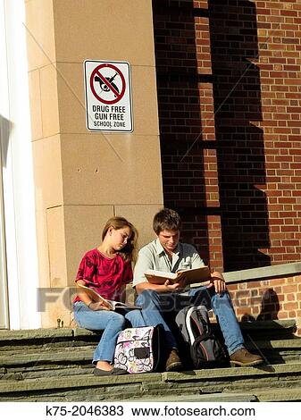 Two students studying together on school steps View Large Photo Image Stock Image - Two students studying together on school steps. Fotosearch