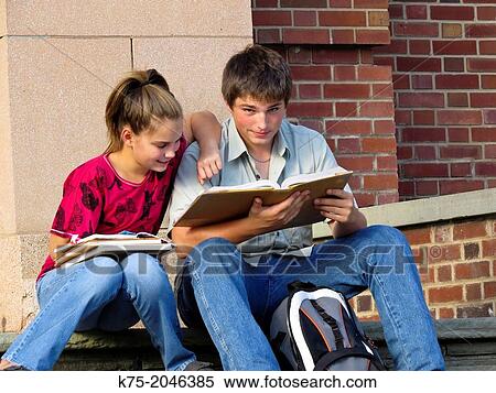 Two students studying together on school steps View Large Photo Image Stock Photography - Two students studying together on school steps. Fotosearch