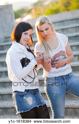 Picture - Two teen girlfriends, looking at a bracelet. Fotosearch