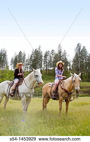 Two teen girls riding horses in Reardan, Washington, USA. View Large Photo Image Stock Photo - Two teen girls riding horses in Reardan, Washington, USA.. Fotosearch