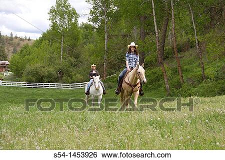 Two teen girls riding horses in Reardan, Washington, USA. View Large Photo Image Stock Photograph - Two teen girls riding horses in Reardan, Washington, USA.. Fotosearch