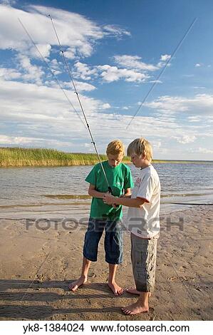 Picture - Two Teenage Boys Fishing by Lake V? rtsj? rv in Estonia. Fotosearch