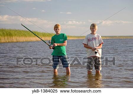 Stock Photography - Two Teenage Boys Fishing by Lake V? rtsj? rv in Estonia. Fotosearch