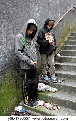 two teenage boys using cell phones to text View Large Photo Image Stock Photo - two teenage boys using cell phones to text. Fotosearch