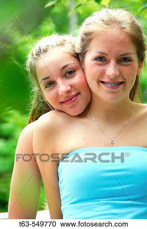 two teenage girls embracing together View Large Photo Image Stock Image - two teenage girls embracing together. Fotosearch