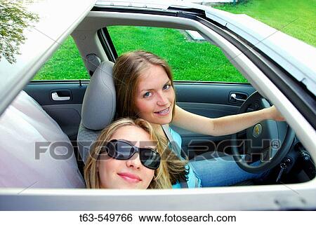 two teenage girls sitting in automobile together looking through sunroof View Large Photo Image Stock Photograph - two teenage girls sitting in automobile together looking through sunroof. Fotosearch