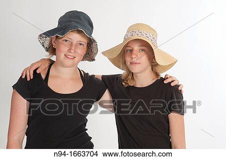 Two teenage girls with hats View Large Photo Image Picture - Two teenage girls with hats. Fotosearch