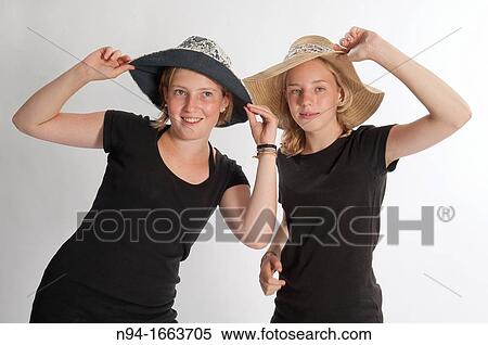 Two teenage girls with hats View Large Photo Image Stock Photography - Two teenage girls with hats. Fotosearch