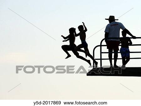 two teenagers jumping together from diving tower to waters of Lake Geneva, Paquis beach, Geneva, Switzerland View Large Photo Image Stock Photo - two teenagers jumping together from diving tower to waters of Lake Geneva, Paquis beach, Geneva, Switzerland. Fotosearch