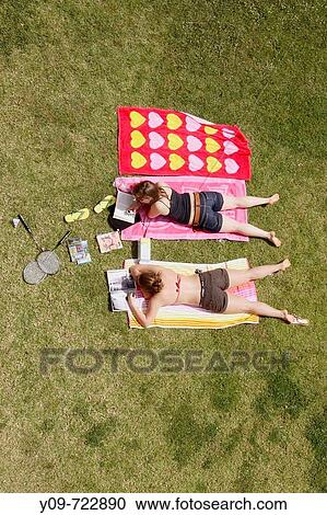 Two teenagers sunbathing View Large Photo Image Stock Image - Two teenagers sunbathing. Fotosearch