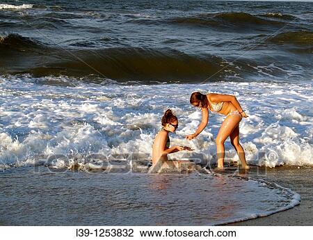 Two Teens-01 are two girls playing in the surf in Kill Devil Hills, NC, USA View Large Photo Image Stock Image - Two Teens-01 are two girls playing in the surf in Kill Devil Hills, NC, USA. Fotosearch