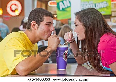 two teens sharing a beverage View Large Photo Image Stock Image - two teens sharing a beverage. Fotosearch