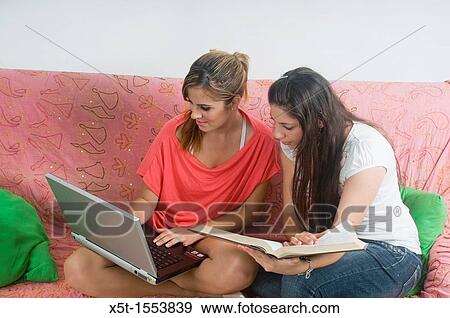 Two teens studing on a couch View Large Photo Image Stock Photo - Two teens studing on a couch. Fotosearch