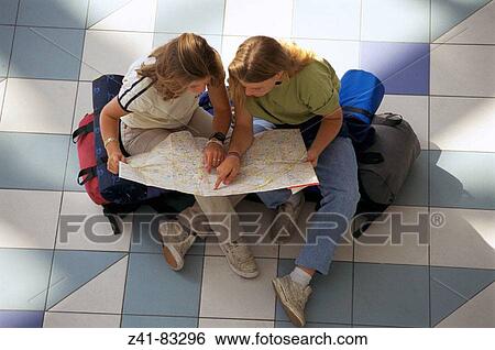 Stock Photograph - Two teens with map. Fotosearch