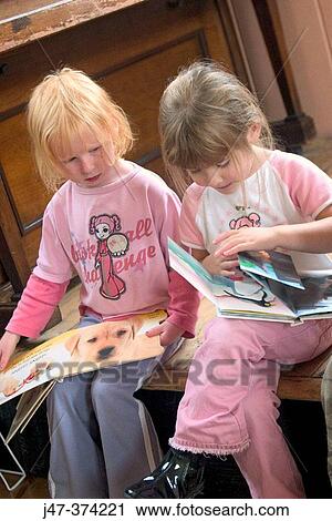 Two, three year old girls at nursrey school reading books together View Large Photo Image Stock Image - Two, three year old girls at nursrey school reading books together. Fotosearch