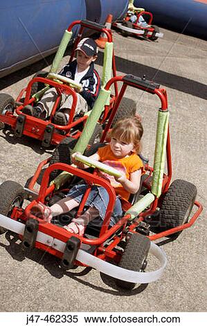 Two three year olds racing go-carts View Large Photo Image Stock Photography - Two three year olds racing go-carts. Fotosearch