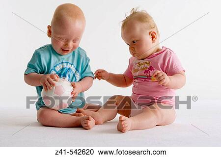 Two toddlers playing with a ball. View Large Photo Image Stock Image - Two toddlers playing with a ball.. Fotosearch