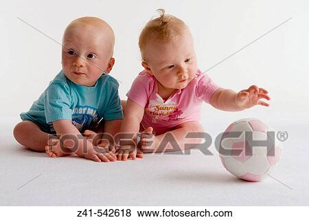 Stock Photo - Two toddlers playing with a ball.. Fotosearch