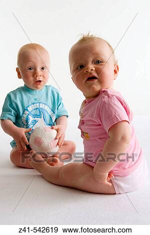Two toddlers playing with a ball. View Large Photo Image Stock Photo - Two toddlers playing with a ball.. Fotosearch
