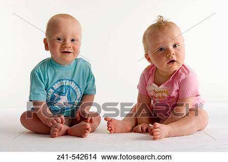 Picture - Two toddlers sitting on the floor.. Fotosearch