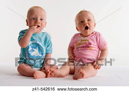 Two toddlers sitting on the floor. View Large Photo Image Stock Photograph - Two toddlers sitting on the floor.. Fotosearch