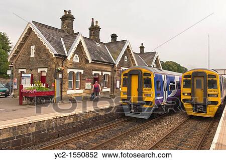 Two trains at the Railway Station at Settle in North Yorkshire, England, Britain, Uk View Large Photo Image Stock Image - Two trains at the Railway Station at Settle in North Yorkshire, England, Britain, Uk. Fotosearch