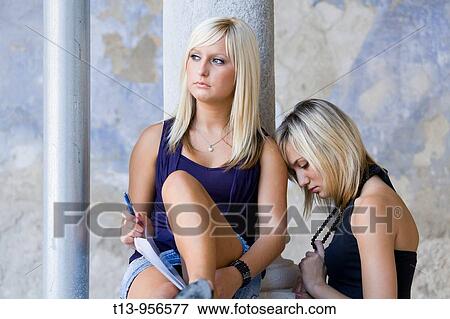 Two unhappy young student women View Large Photo Image Stock Photo - Two unhappy young student women. Fotosearch