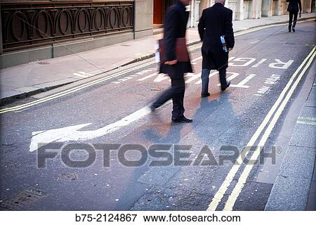 two unrecognizable and relaxed executive walking down in the street in London, England, UK, Europe View Large Photo Image Stock Photo - two unrecognizable and relaxed executive walking down in the street in London, England, UK, Europe. Fotosearch