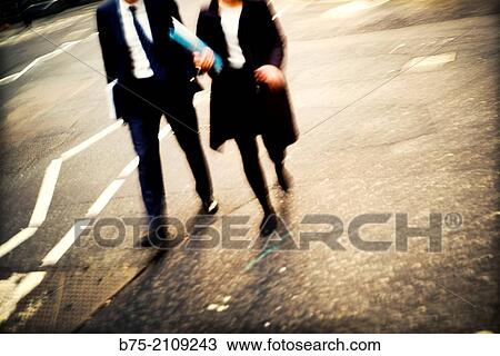 Two unrecognizable executive, men and a woman, walking down the street with a folder. London, England, UK, Europe View Large Photo Image Stock Image - Two unrecognizable executive, men and a woman, walking down the street with a folder. London, England, UK, Europe. Fotosearch