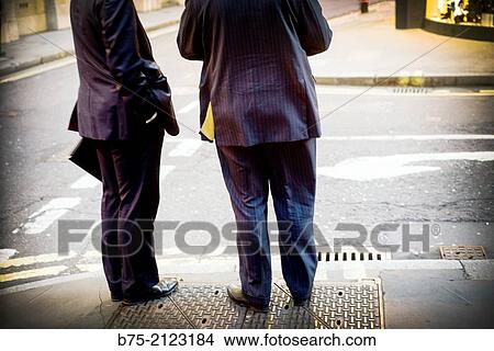 two unrecognizable executives talking in the street in London, England, UK, Europe View Large Photo Image Picture - two unrecognizable executives talking in the street in London, England, UK, Europe. Fotosearch