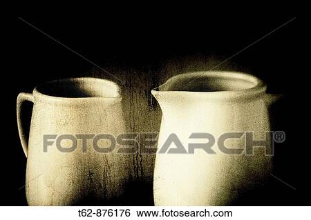 Stock Photograph - Two white mugs with steaming hot drink. Old texture. Still Life. Fotosearch